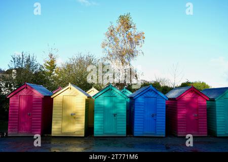 Bunte Strandhütten in einer Reihe unter blauem Himmel. Stockfoto