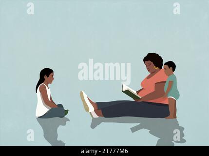 Schwarze Mutter sitzt und liest ein Buch für Tochter und Sohn Stockfoto