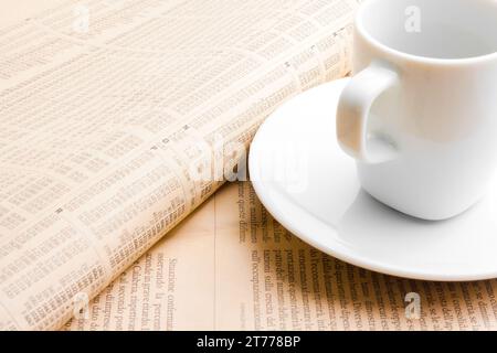 Finanzzeitung in der Nähe einer Tasse Kaffee Stockfoto