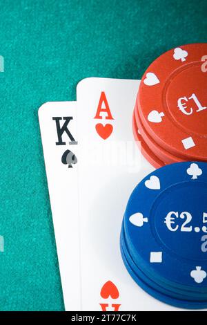 Details zu Pokerkarten und Spielchips auf dem grünen Spieltisch Stockfoto