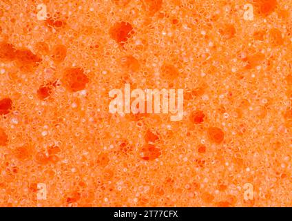 Orangefarbener Schwamm als Hintergrund Stockfoto