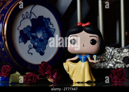 Funko Pop Actionfigur der Disney Prinzessin Schneewittchen mit Vogel. Wunderschöner Palast, fabelhaftes Königreich, Säulen, rote Rosen, Vintage Blue Fass. Stockfoto