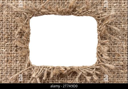 Loch in Sackleinen. Gerissenes Stück Sackleinen mit einem Loch in der Mitte Stockfoto
