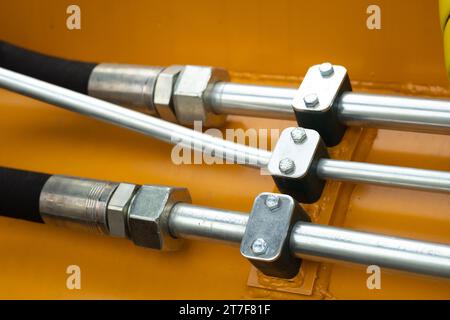 Nahaufnahme einer Baugruppe mit Hydraulikleitungen und Kupplungen an einem Lkw. Stockfoto