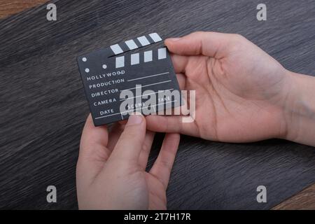 Hand-Halten-Filmklapper auf dunklem Hintergrund Stockfoto