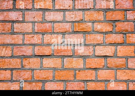 Alte rustikale Ziegelmauer aus roten Ziegeln. Hintergrund. Stockfoto