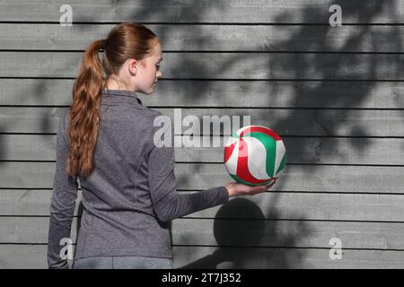 Teenager-Mädchen, das Volleyball hält Stockfoto