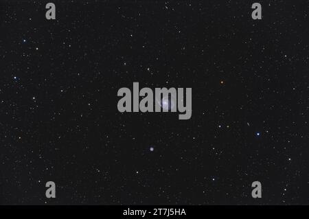 Dies ist ein Rahmen der hellen Messier-Spiralgalaxie M101 mit einer Reihe ihrer nahe gelegenen Galaxien in Ursa-Major. Die ungerade Galaxie unter M101 in NGC 5474 Stockfoto