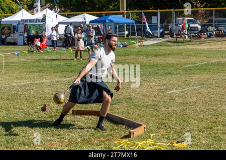 Ein Wettbewerber im Kilt wirft den Ball im Highland-Gewichtheben beim Moab Celtic Festival, Scots on the Rocks, in Moab, Utah. Stahl b Stockfoto