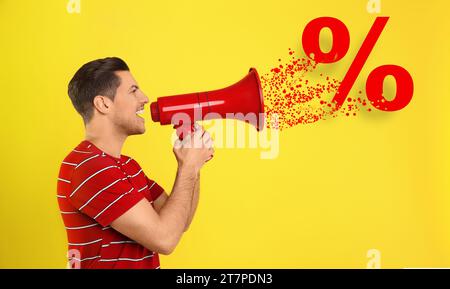 Rabattangebot. Ein Mann, der in Megaphon auf gelbem Hintergrund schreit. Prozentzeichen kommt vom Gerät Stockfoto