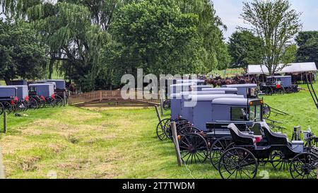 Eine große Gruppe von Amish Horse und Buggys für eine Veranstaltung in Lancaster, Pennsylvania an einem sonnigen Sommertag Stockfoto