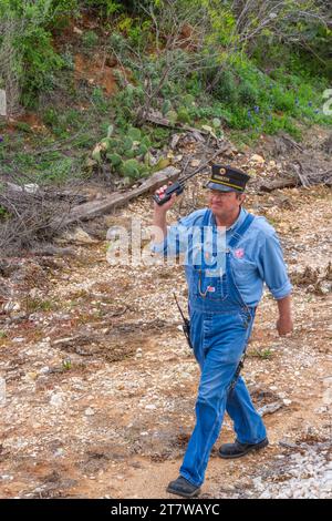 Eisenbahnangestellter, der sowohl als Zugbegleiter als auch als Bremser im Hill Country Flyer-Zug fungiert, verlässt das Heck des Zuges, um Schalter zu bedienen. Stockfoto