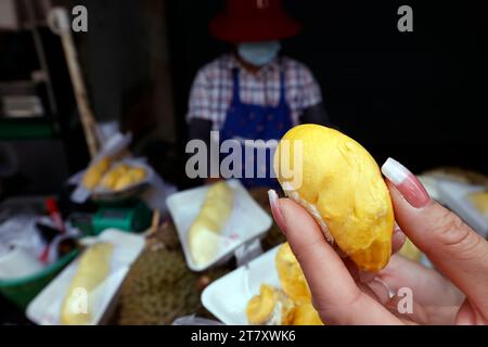 Eine Frau bereitet Durian-Früchte zum Verkauf an einem bei Touristen und Einheimischen beliebten Street-Food-Stand vor, in Bangkok, Thailand, Südostasien und Asien Stockfoto