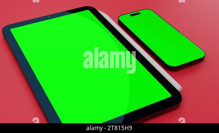 Tablet und Smartphone mit leerem grünem Display auf der Oberfläche. Stockfoto