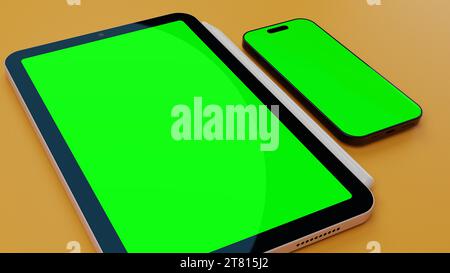 Tablet und Smartphone mit leerem grünem Display auf der Oberfläche. Stockfoto