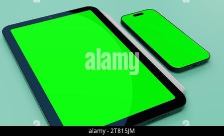 Tablet und Smartphone mit leerem grünem Display auf der Oberfläche. Stockfoto