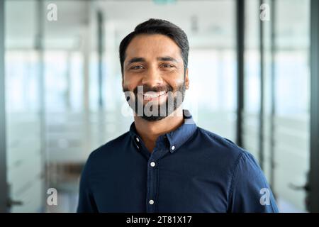 Glücklicher, bärtiger indischer Geschäftsmann, der im Amt steht, Kopffoto-Porträt. Stockfoto