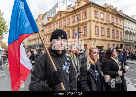 Prag, Tschechische Republik. November 2023. Ein junger Mann hält eine tschechische Flagge in der Prager Narodni-Straße. Die Tschechische Republik feierte den 34. Jahrestag der Samtenen Revolution anlässlich der Ereignisse vom 17. November 1989, als nach der Unterdrückung einer Studentendemonstration in der Narodni-Straße das kommunistische Regime bald zusammenbrach. Der Dramatiker und Menschenrechtsaktivist Vaclav Havel wurde kurz nach dem Sturz des kommunistischen Regimes Präsident. Quelle: SOPA Images Limited/Alamy Live News Stockfoto