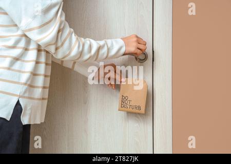Frau mit Türbügel im Hotelzimmer, Nahaufnahme Stockfoto