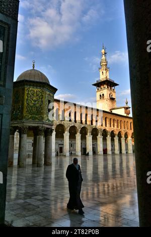 Eine einheimische Frau in einem Hijab, die im Innenhof der Umayyaden-Moschee in Damaskus, Syrien, spaziert Stockfoto