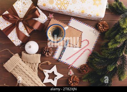 Notizblock für weihnachtsbrief, Geschenkverpackung, Schneetanne und Kaffeetasse. Draufsicht Stockfoto