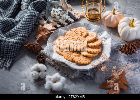 Chai Latte Kekse oder Ingwerkekse mit Kürbissen und Kerzen für die Herbstsaison Stockfoto