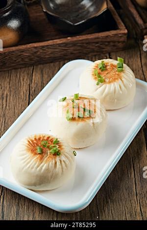 Sheng Jian Bao, in der Pfanne gebratener Brötchen im Shanghai-Stil gefüllt mit Schweinefleisch Stockfoto