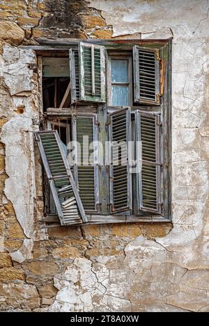 Altes kaputtes Fenster mit Holzläden. Pufferzone. Nikosia. Zypern. Stockfoto