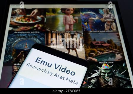 Emu Video Tool Logo auf Smartphone und seine Beispiele im Hintergrund. Neues KI-Video-Generierungstool von Meta. Stafford, Großbritannien, 19. November 2023 Stockfoto