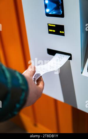 Frau, die eine Quittung vom Selbstkasse-Automaten erhält Stockfoto