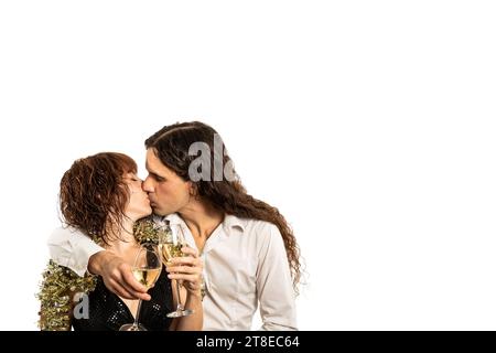 Horizontal Mittel Nahaufnahme kaukasisches Paar mittlerer Erwachsener, küssend, elegante Kleider. Silvester feiern, mit Champagner anstoßen. Weißer Hintergrund Stockfoto