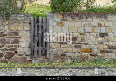Mauer auf dem Schlossberg in Quedlinburg aus Steinsteinen mit einer schmalen Holztür Stockfoto