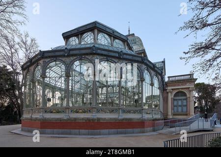 Viktorianischer Glaspavillon in einem Park in der Abenddämmerung, der das Dämmerungslicht reflektiert. Stockfoto