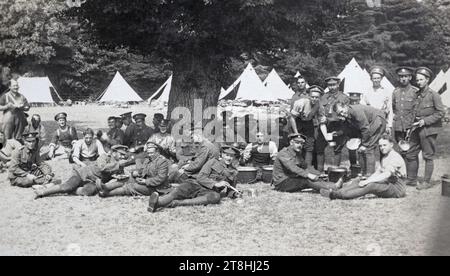 Britische Soldaten essen und entspannen im Lager unter einem Baum, um 1915. Stockfoto