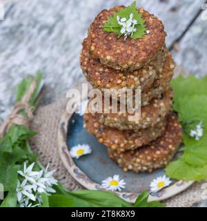 selbstgemachte Kräuterpasteten mit wildem Knoblauch auf einem Teller, dekoriert mit Gänseblümchen Stockfoto