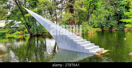 Diminish and Ascend i, Diminish and Ascend ist von David McCracken aus Auckland, Neuseeland. Das Stück ist eine 13 Meter lange, perspektivische Treppe aus Aluminium, die im Kiosk Lake des Botanischen Gartens Christchurch, Neuseeland, installiert wurde Stockfoto