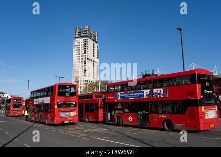 Lokale Menschen und rote Londoner Busse am 17. November 2023 in London, Vereinigtes Königreich, am Hauptverkehrsknotenpunkt Transport for London der Stratford City Bus Station im Borough of Newham. Stratford ist heute das wichtigste Einkaufs-, Kultur- und Freizeitzentrum in East Londons. Außerdem ist es der zweitwichtigste Geschäftsstandort im Osten der Hauptstadt. Stockfoto