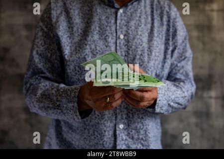 Konkurs Geld ohne Grenzen ausgeben Schulden Steuern Euro in den Händen eines Mannes Stockfoto