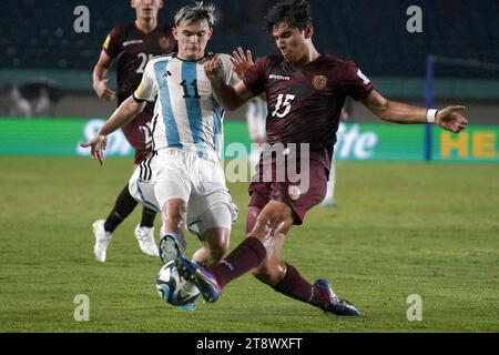 Bandung, Indonesien. November 2023. Santiago Lopez (L) von Argentinien streitet mit Angel Borgo von Venezuela im Achtelfinale der FIFA U-17-Weltmeisterschaft Indonesien 2023 zwischen Argentinien und Venezuela im Jalak Harupat Stadium in Bandung, West-Java, Indonesien, 21. November 2023. Quelle: Septianjar Muharam/Xinhua/Alamy Live News Stockfoto