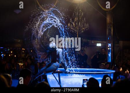 München, Deutschland. November 2023. Eine Künstlerin führt ihre Wasserakrobatik während der Jubiläumsshow auf, um „20 Jahre Teatro“ zu feiern. Das Gastro-Zelt „Teatro“ feierte am Dienstag seinen 20. Geburtstag und seinen Relaunch unter neuem Chef Michael Käfer. Quelle: Lennart Preiss/dpa/Alamy Live News Stockfoto