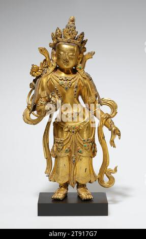 Bodhisattva, ein Paar, 18. Jahrhundert, 9 1/2 x 4 7/8 x 1 7/8". (24,1 x 12,4 x 4,8 cm), vergoldete Bronze, China, 18. Jahrhundert, obwohl sie sich spiegelbildlich darstellen, stellen diese beiden Statuen wahrscheinlich nicht denselben Bodhisattva dar; sie sind wahrscheinlich eher die beliebten Gottheiten Maitraya und Avalokitesvara. Sie standen in anmutiger Haltung und hielten den Stiel einer Lotusblume und bildeten wahrscheinlich Teil einer skulpturalen Triade, die ein größeres Bronzebild des Buddha flankierte Stockfoto