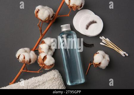 Flache Lay-Zusammensetzung mit Flasche Make-up-Entferner auf grauem Hintergrund Stockfoto