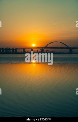 Sonnenaufgang auf dem Changjiang/Yangtze Fluss über eine Stahlbrücke Stockfoto