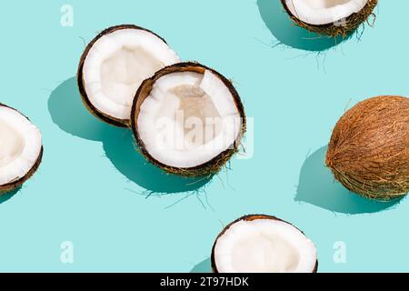 Halbierte frische Kokosnüsse vor blauem Hintergrund Stockfoto