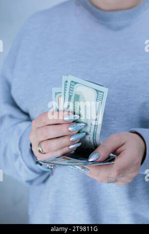 Die Hände der Frau halten amerikanische Dollarpapierscheine Stockfoto