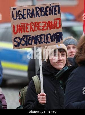 Greifswald, Deutschland. November 2023. Eine Frau trägt während eines Warnstreiks von Mitarbeitern der Universitätskliniken Greifswald und Rostock ein Schild mit der Aufschrift „überarbeitet - unterbezahlt - systemrelevant“. Die gewerkschaft Verdi hat zu Warnstreiks an Universitätskliniken in ganz Deutschland aufgerufen. Verdi fordert 10,5 Prozent mehr Einkommen für die Beschäftigten im öffentlichen Dienst der bundesländer, aber mindestens 500 Euro mehr pro Monat. Quelle: Bernd Wüstneck/dpa/Alamy Live News Stockfoto