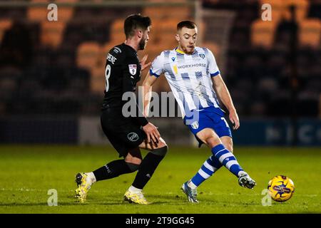 Barrows Kian Spence (links) und Arthur Read von Colchester United kämpfen um den Ball während des Spiels der Sky Bet League Two im JobServe Community Stadium in Colchester. Bilddatum: Samstag, 25. November 2023. Stockfoto