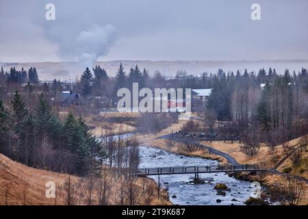 Isländisches geothermisch aktives Dorf Hveragerði mit Dampfportionen aus dem Boden, Fluss Varmá Stockfoto