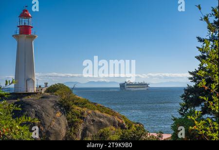 Kreuzfahrtschiff, das den Hafen von Vancouver BC verlässt. Der Blick auf einen Leuchtturm und ein Kreuzfahrtschiff im Meer. Stockfoto