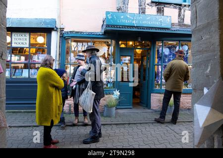 Leute Freunde unterhalten sich vor den Geschäften der Stadt Hay-on-Wye im Christimas während des Hay Winter Festival Buchfestivals in Wales, Großbritannien KATHY DEWITT Stockfoto